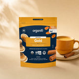 Organifi Gold pouch beside a prepared golden drink in a glass