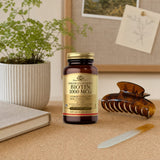 Solgar Biotin 1000 mcg 250 capsules on a bathroom vanity with a hair brush